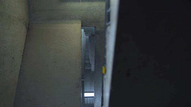 Rack focus up parking garage staircase