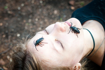 Young woman with a bugs on face