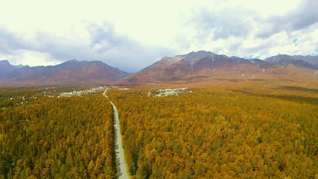 Autumn. Transition from summer to fall. Aerial shot of forest and mountains