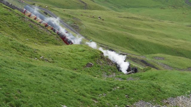 vintage steam train entering a tunnel with smoke puffing mountain train brienzer rothorn