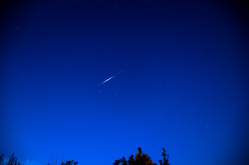 Iridium flare in the night sky in the countriside near