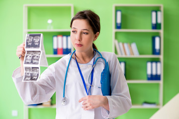 Female doctor gynecologyst writing medical record in the clinic