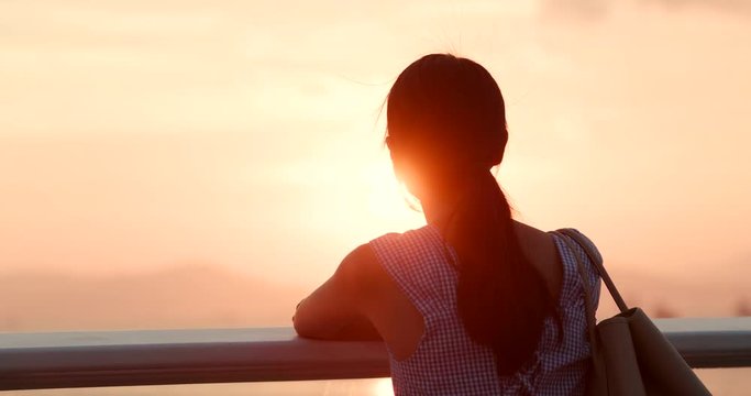 Woman looking at the sunset