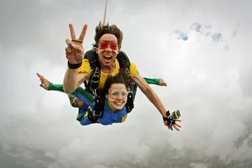 Poster Im Rahmen Skydiving tandem happiness on a cloudy day © Mauricio G