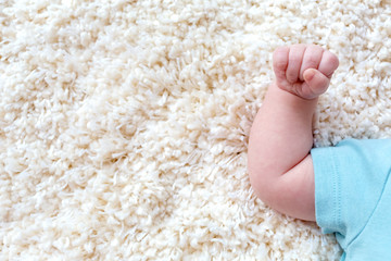 Fototapeta na wymiar Newborn baby boy's little arm while laying down