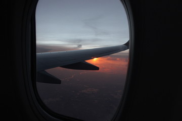 sunset view from airplane window, with wing