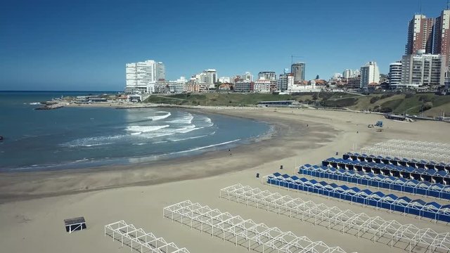 Playa Varese on the coast of Mar del Plata Argentina – 4k drone video of the Argentinian coast and downtown area of Mar del Plata Casino Central in spring time.  Buenos Aires Capital Federal district 