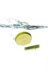 Lime Slices Falling into Water