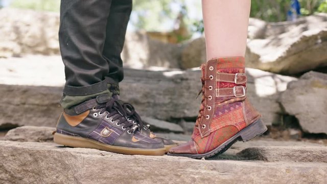 Close up of couples feet, folk steampunk artsy shoes, females feet moves up onto her tippy toes