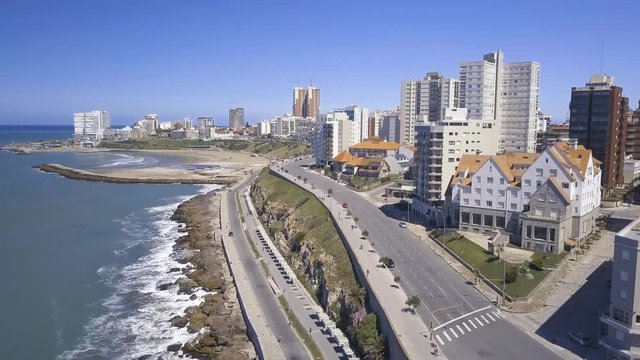 Rambla Patricio Ramos at Playa Varese on the coast of Mar del Plata Argentina – 4k drone video of the Argentinian coast Mar del Plata Casino Central in spring.  Buenos Aires Capital Federal district  