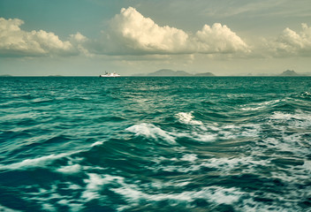 White ferry ship going to sea with waves