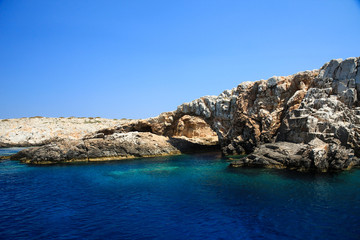 Fototapeta na wymiar A cave in the deep blue sea of Astypalaia island in Greece