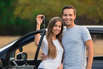 Portrait of a Couple by Car Holding Car Key
