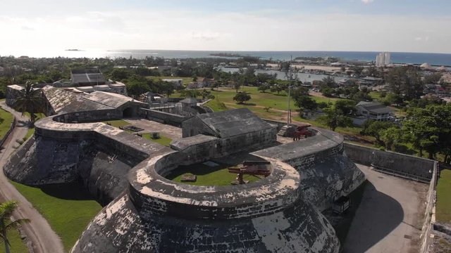 4K Aerial view of the historical Fort Charlotte in Nassau Bahamas. This is a lifting shot with a bird flying through.