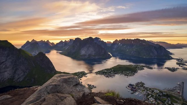 Timelapse of midnight sun hiding behind the beautiful peaks of Lofoten Islands, Norway.