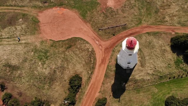 Person walking towards lighthouse