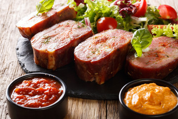 Fried pork brisket and fresh salad, ketchup and mustard. horizontal