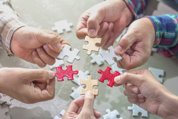 Closeup of businessman and woman with jigsaw puzzle pieces,strategy concept.