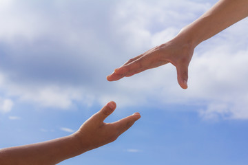 Helping hands, sky background, Rescue concept, religion.