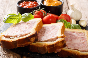 Meat terrine, pate with spices, garlic served with vegetables and sauces close-up. horizontal