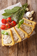 chicken terrine, jelly, aspic with brioche served with herbs and vegetables close-up. Vertical top view