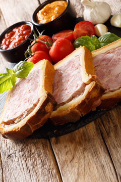 Pork terrine, pate with brioche with spices, garlic served with vegetables and sauces close-up. horizontal