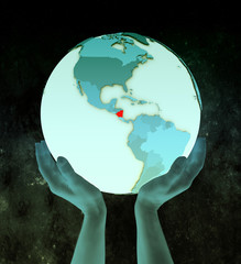 Nicaragua on blue globe in hands