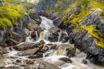 Fototapeta premium Norwegian Waterfall with long exposure and blurred water flow