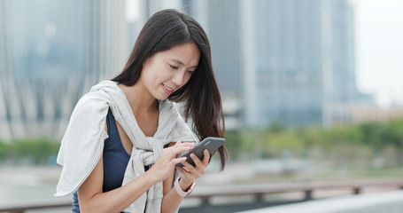 Woman use of mobile phone in city