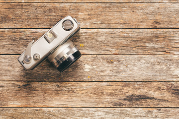 35mm film camera on weathered wooden background