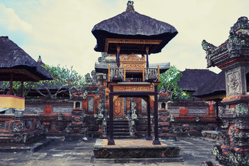 Traditional hindu buildings of old temple. Temple and beauty rock statue at the temple in Bali. Bali pavilion hindu temple with grass roof. Travel concept.