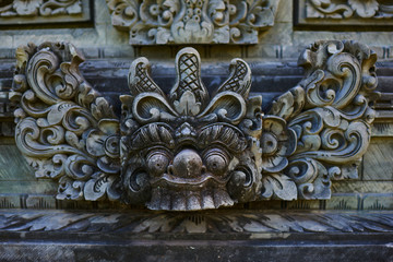 Beautiful view of ancient stone carving of temple on Bali island. Balinese hindu temple ornamented by carvings and sculptures. Old hindu architecture, ancient design. Summer and vacation concept.