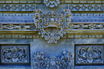 Beautiful view of ancient stone carving of temple on Bali island. Balinese hindu temple ornamented by carvings and sculptures. Old hindu architecture, ancient design. Summer and vacation concept.