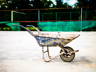 old empty blue construction trolley for transport concrete cement sand or other equipment and tools in civil engineering work at site.