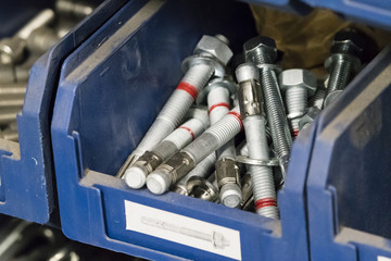 Metal anchors in a plastic box.