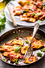 Italian or mediterranean food pasta ravioli of tomato sauce.