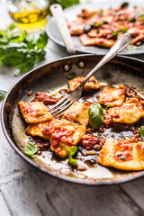 Italian or mediterranean food pasta ravioli of tomato sauce.