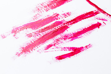 Nail polish on a white background in the form of strips and drops