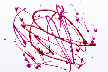 Nail polish on a white background in the form of strips and drops