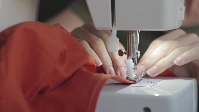 Sewing at home with a machine.