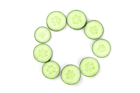Cucumber slices in circle on white background with copyspace