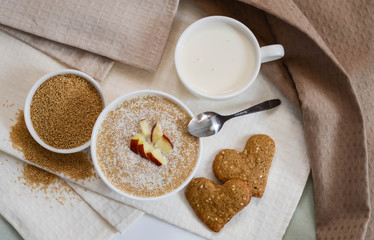 Healthy breakfast. Sesame dry cookies in the form of heart porridge of amaranth with apples  and yogurt..