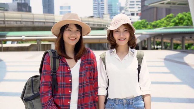 Traveler backpacker Asian women lesbian lgbt couple travel in Bangkok, Thailand. Happy young female spending holiday trip at amazing landmark and enjoy her journey in traditional city.