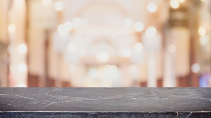 Empty black marble stone table top on blurred with bokeh shopping mall background - can be used for display or montage your products