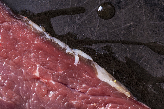 Cooking raw beef meat with fat