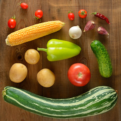 Vegetables laid out on a wooden table. Flat lay,top view.