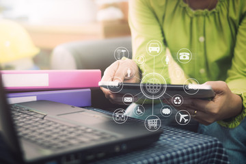 Businesswoman in casual dress holding tablet with online while making orders with virtual icon diagram.