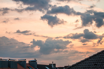 Obraz premium Roofs with chimneys and dramatic sky