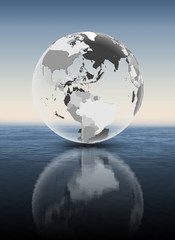 Caribbean on translucent globe above water