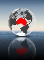 Australia on translucent globe above water